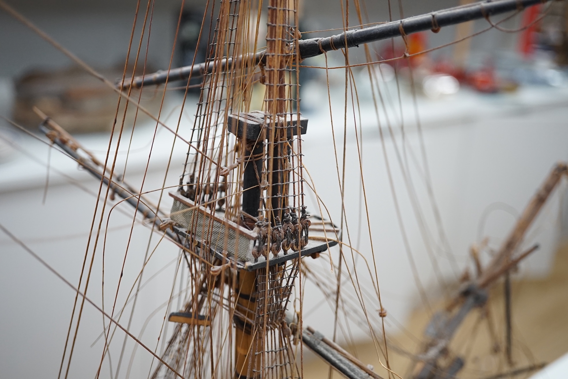 A large model of a rigged ship, 84cm long. Condition - fair